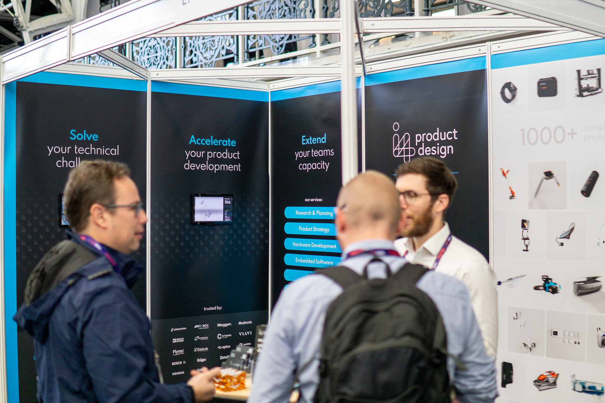 people talking at the i4 Electronics design consultancy exhibition stand at the hardware pioneers event